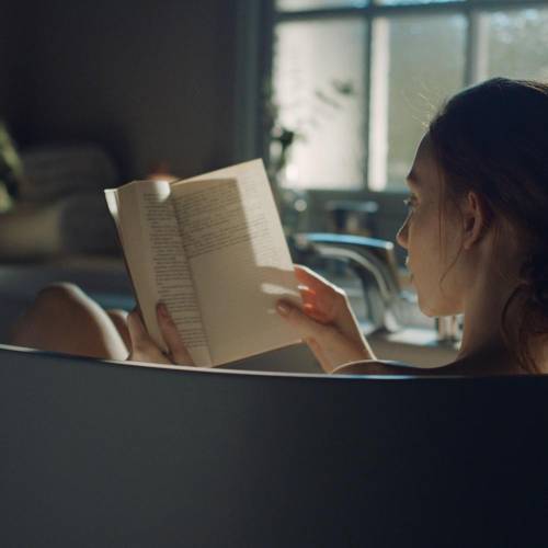 Woman reading a book on a bath